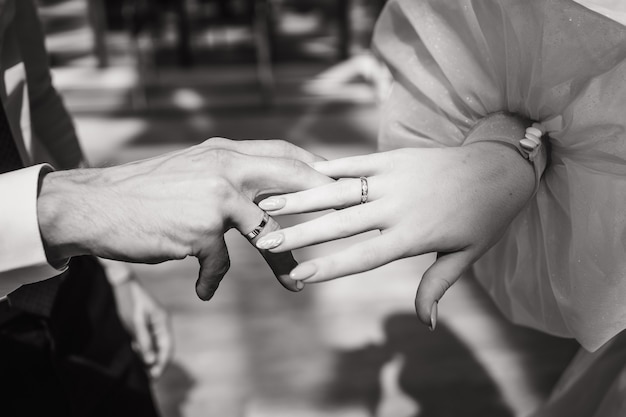 Closeup of the brides and grooms hands black and white photo of the bride and groom a place for text...