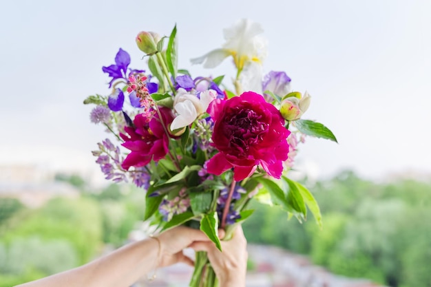 Closeup of bright bouquet of flowers in female hand