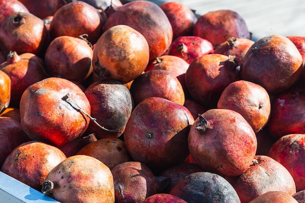 Closeup of bright fruits for background texture Red ripe pomegranates on display