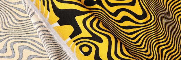 Closeup of bright yellow cotton fabric with black lines print textile with front and back side