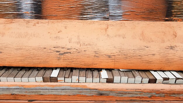 Closeup of a broken piano keyboard of an old piano.