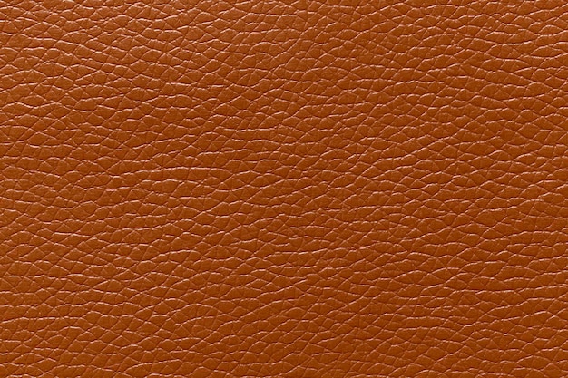 Closeup of a brown leather and a textured background