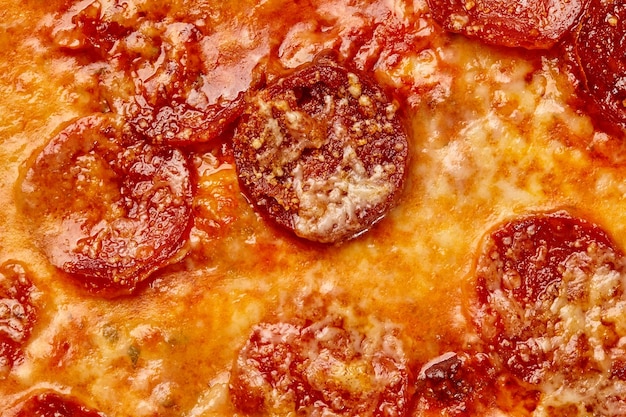 Closeup of browned melted mozzarella cheese on baked pepperoni pizza