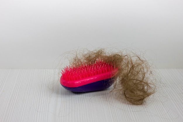 Closeup of a brush with lost hair on it on white background