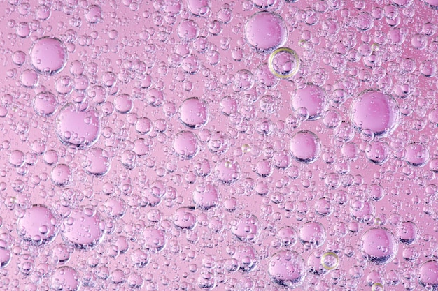 Closeup bubbels olie in water op roze achtergrond macro afbeelding zoete kleur abstracte heldere wallpape