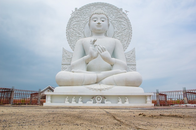 Photo closeup the buddha white sit down isolated on white background.