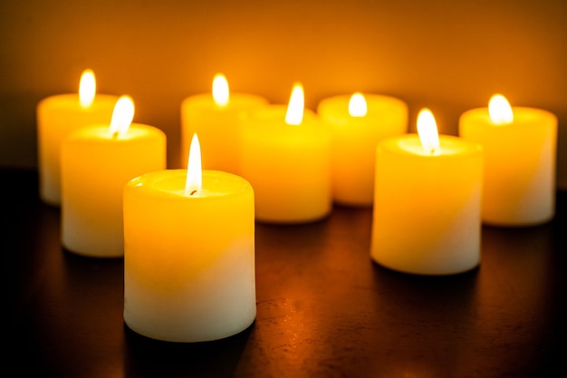 Closeup to burning candles in darkness