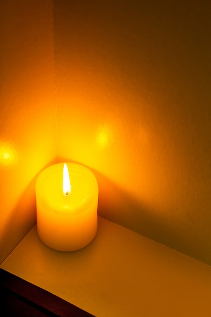 Closeup to burning candles in darkness