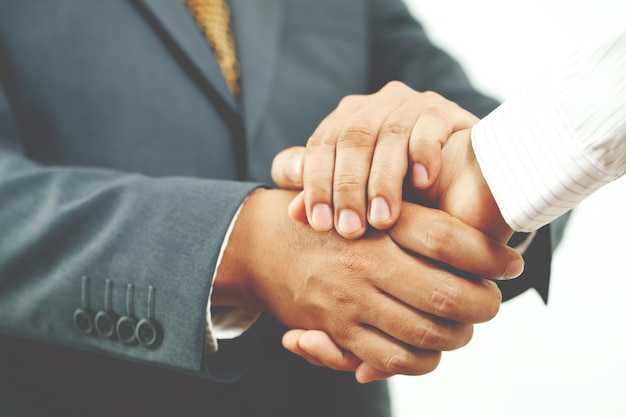 Closeup of a business hand shake between two colleagues Plaid shirt