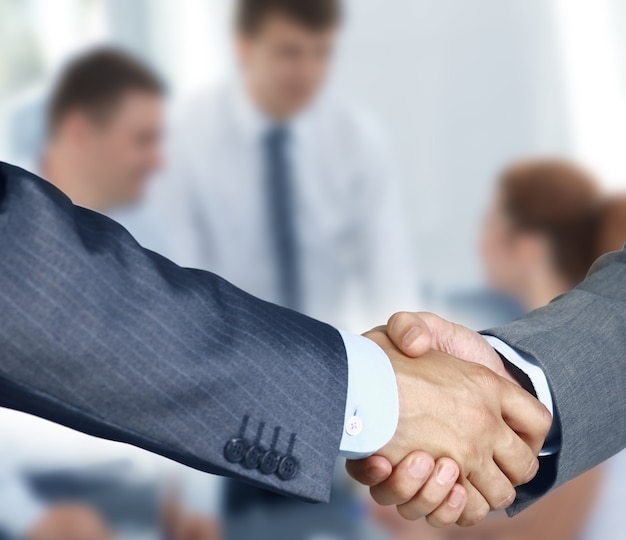 Closeup of a business hand shake between two colleagues