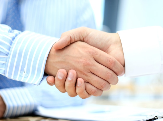 Closeup of a business hand shake between two colleagues