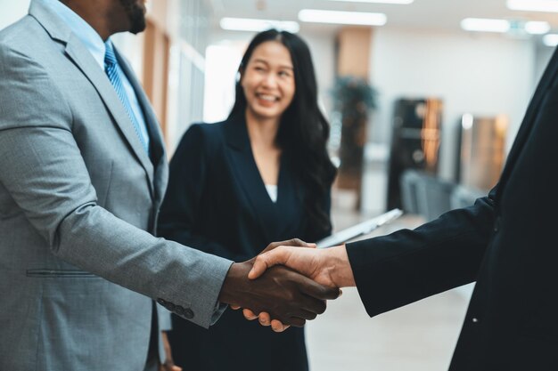 Photo closeup of business hands shaking while businesswoman standing ornamented