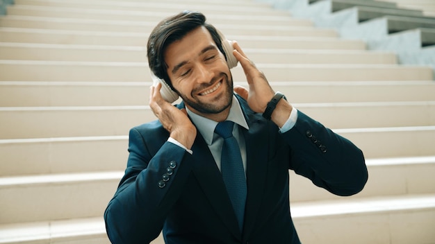 Closeup of business man enjoy to listen music by using headphone Exultant