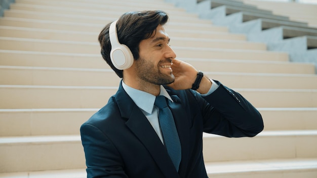 Photo closeup of business man enjoy to listen music by using headphone exultant