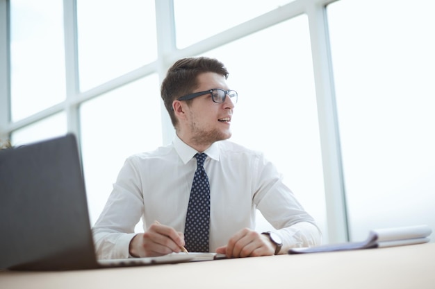 Closeup of business man writing form on clipboard at office