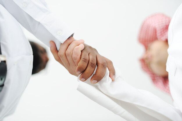 Closeup of business people shaking hands over a deal