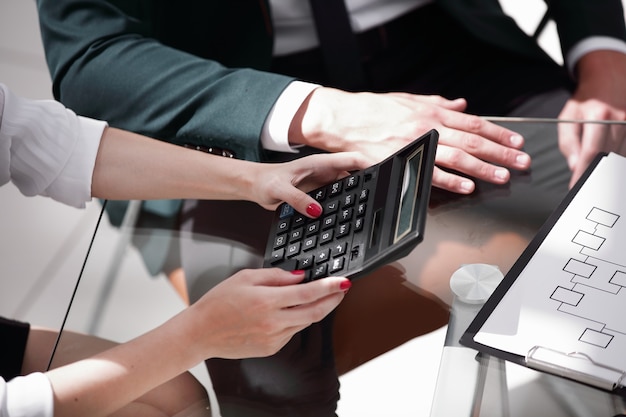 Closeup.business woman working with a calculator