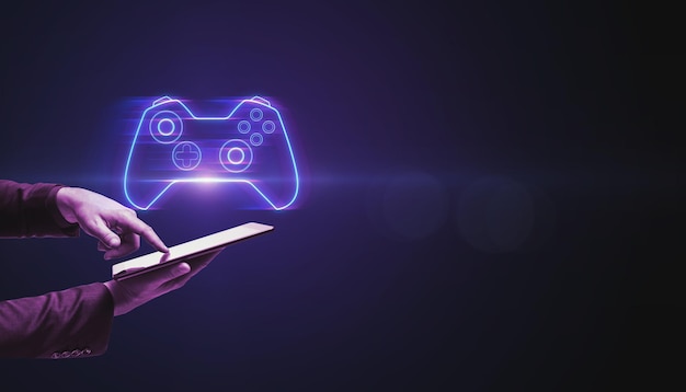 Closeup of businessman hand pointing at cellphone with creative joystick or gamepad hologram on blurry purple bokeh background Esport gaming and fun concept