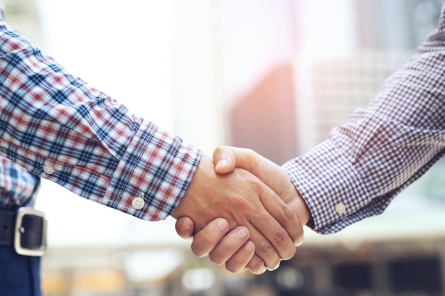 Closeup of a businessman hand shake between two colleagues  OK, succeed in business Holding hands. Leave space to write a description of the message.