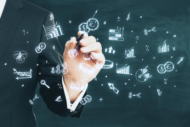 closeup of a businessman hand sketching financial concepts on a chalkboard