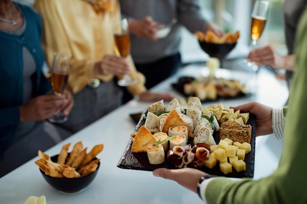 Closeup of businessman serving food on office party