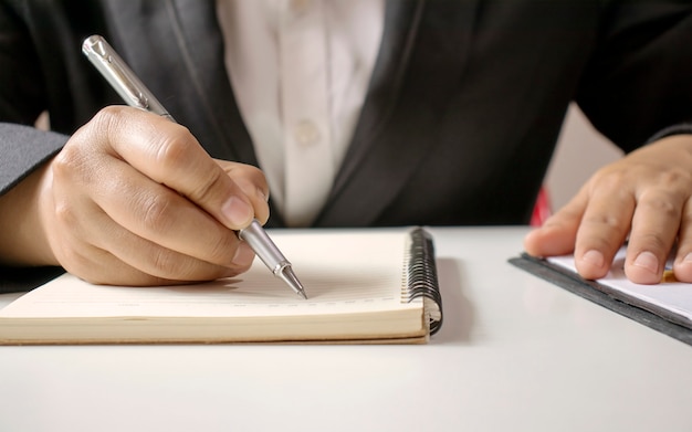 Closeup of a businessman using pen to write