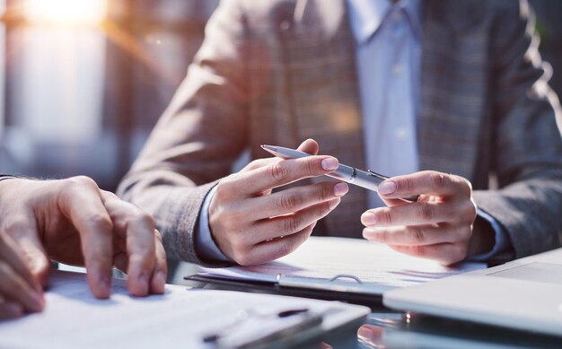 Closeup a businessman using a stylus signs a document in the office