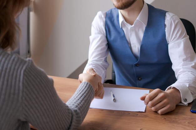 Closeup businessmen hands greet each other starting negotiations handshake HR