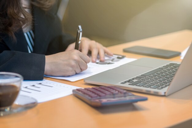 Closeup businesswoman hand writing when working