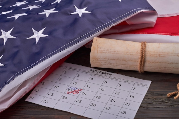 Closeup calendar with september th with scroll and us flag we the people preamble writted on ancient