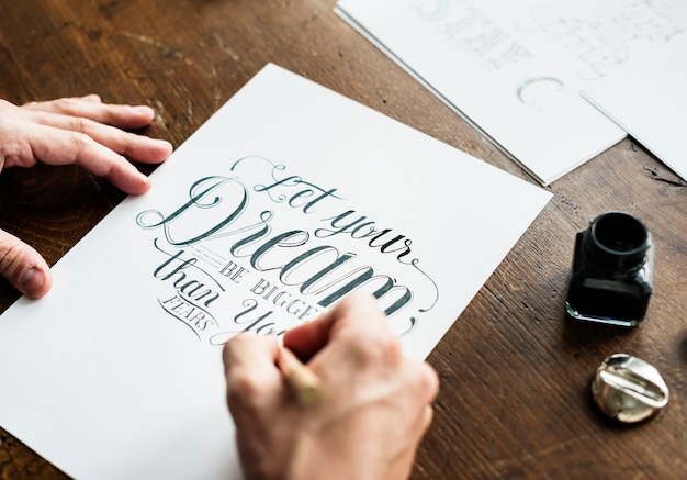 Photo closeup of a calligrapher working on a project