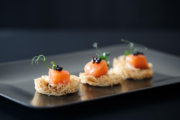 closeup canape with salmon and caviar menu