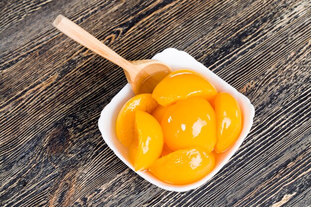 Closeup canned ripe orange peaches