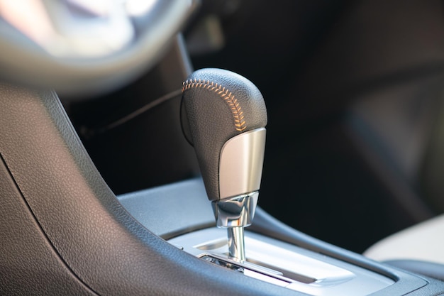 Closeup of car automatic transmission gear stick. Detail of vehicle interior.