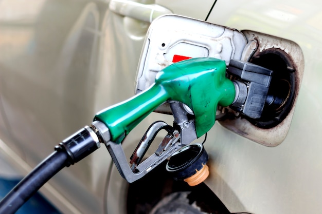 Closeup car refueling on a petrol station white car 