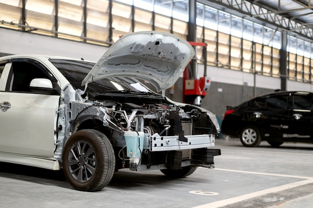 Closeup car repair in garage service station 