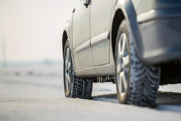 Closeup of car wheels rubber tire in deep snow Transportation and safety concept