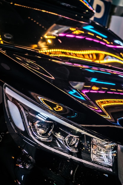 Closeup of car with neon lights on night street