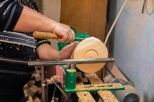 Closeup of carpenter turning wood on a lathe