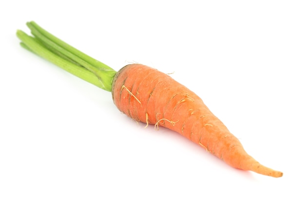 Closeup of carrot with leaf over white background