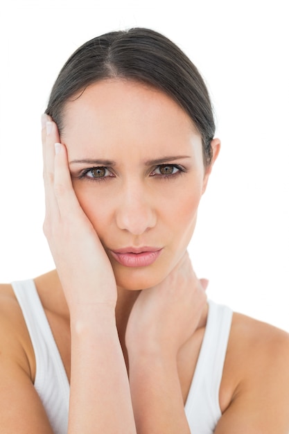 Closeup of a casual woman suffering from headache