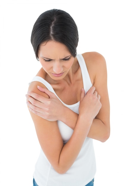 Closeup of a casual woman with shoulder pain