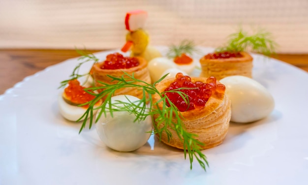 Closeup of caviar and cream cheese appetizer on crackers