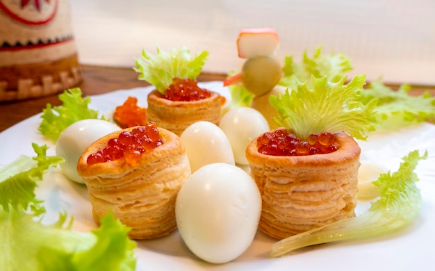 Closeup of caviar and cream cheese appetizer on crackers