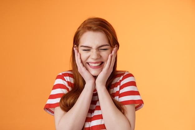 Closeup cheerful lucky excited smiling girl cannot believe cheering hear excellent news close eyes c...