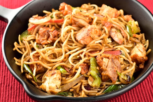 Closeup of chicken chow mein in pan