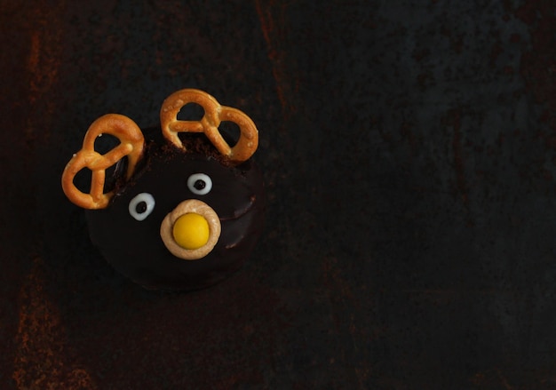 Closeup of a chocolate cake in the form of a deer on a dark background