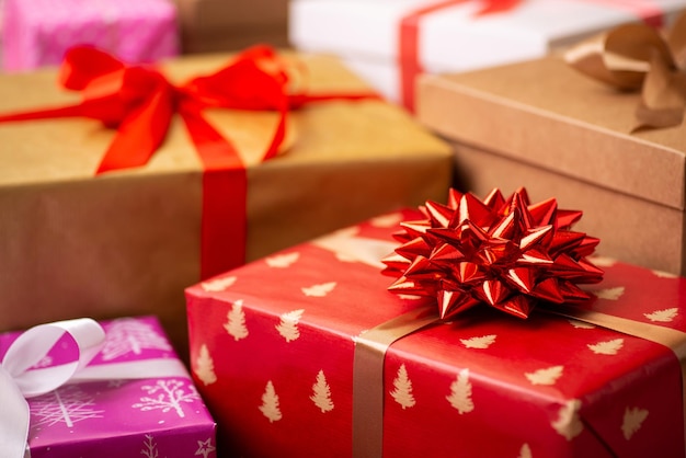 Closeup of Christmas presents Focus on Christmas present box with red wrapping paper and small christmas tree silhouettes