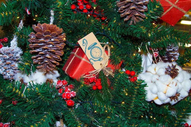 Closeup of a Christmas tree with berries cones and cotton balls Christmas background