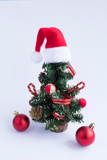 Closeup on Christmas tree with Santa Claus hat on the white background Location vertical